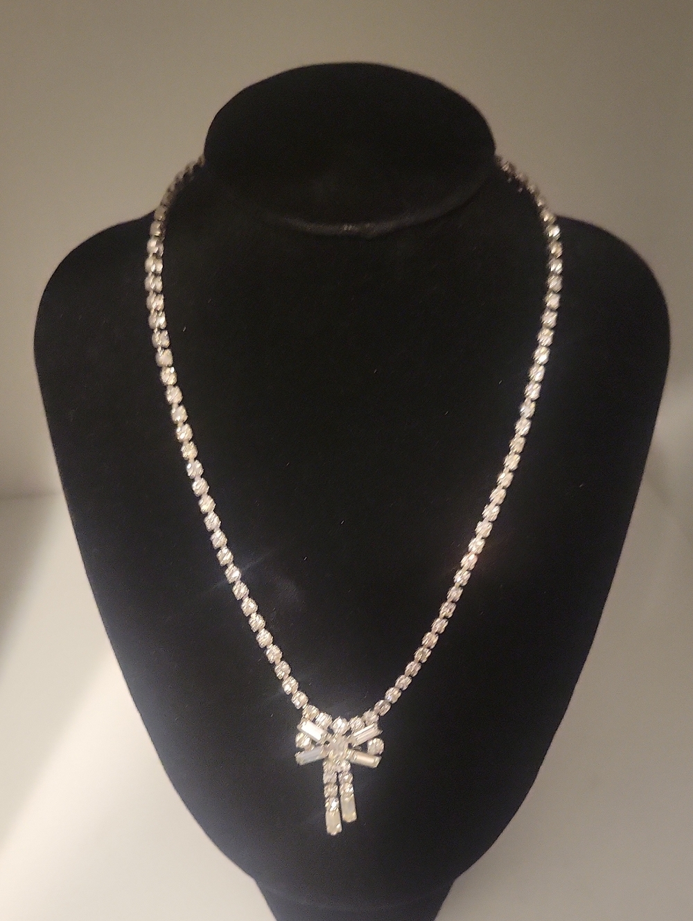 Silver Crystal Ribbon Pendant Necklace - Sparkling Bow Accent marked Denbe